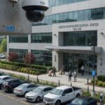 Commercial surveillance camera monitoring a business office entrance