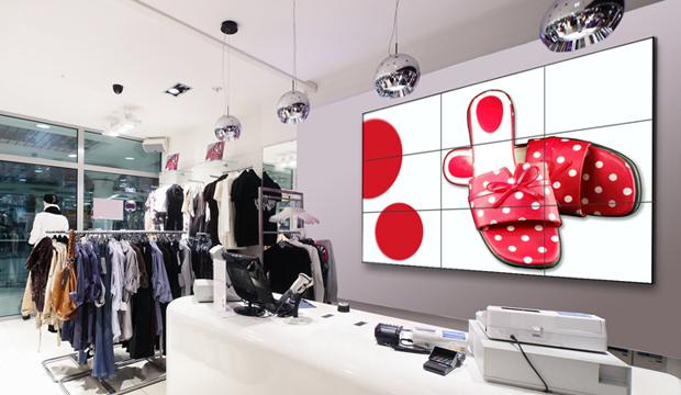 Retail video wall and digital signage display above checkout area